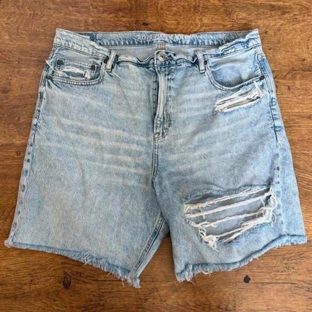 American Eagle distressed blue denim shorts with dark spots around left leg